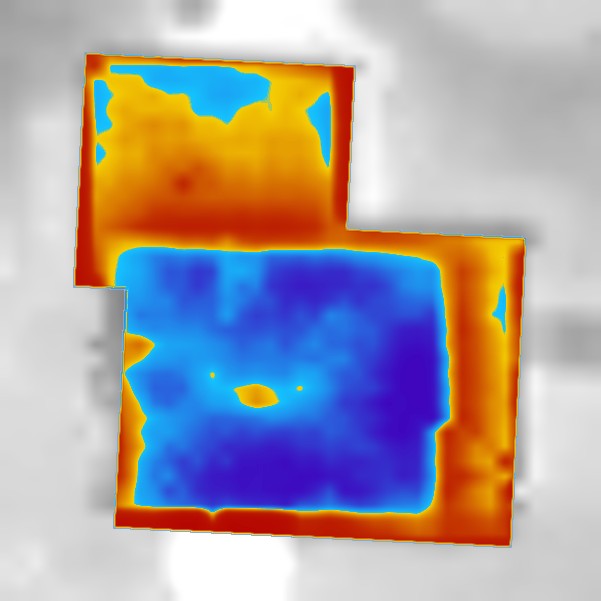 An aerial heat loss map of a residential home showing relative heat loss on a blue to red scale